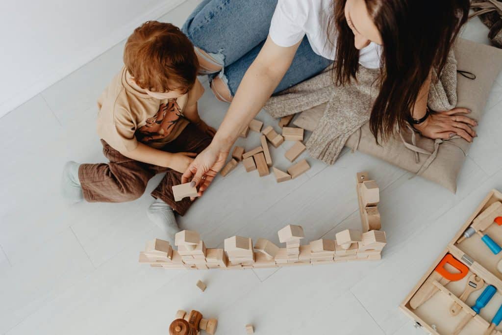Woman Playing with Toy Blocks with Son