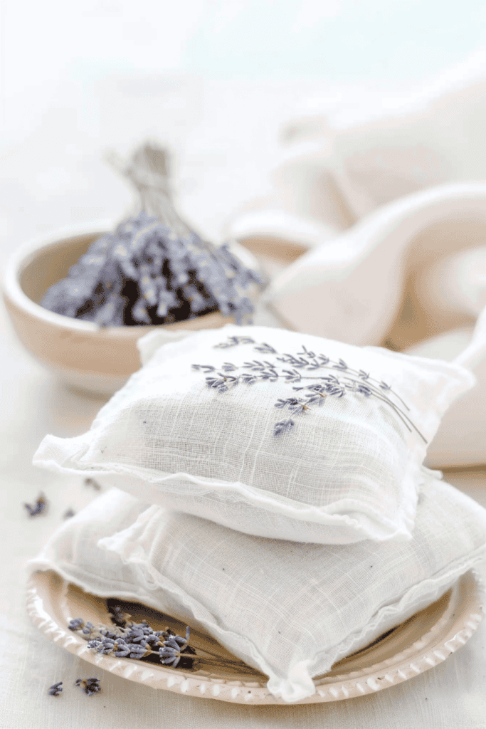 handmade lavender sachets, small white cotton fabric pillows with delicate embroidery