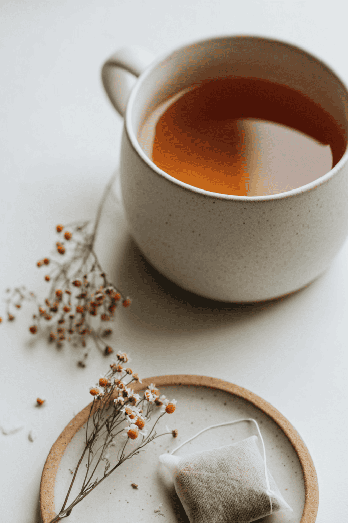 Close-up of calming tea setup, simple ceramic mug with warm herbal tea