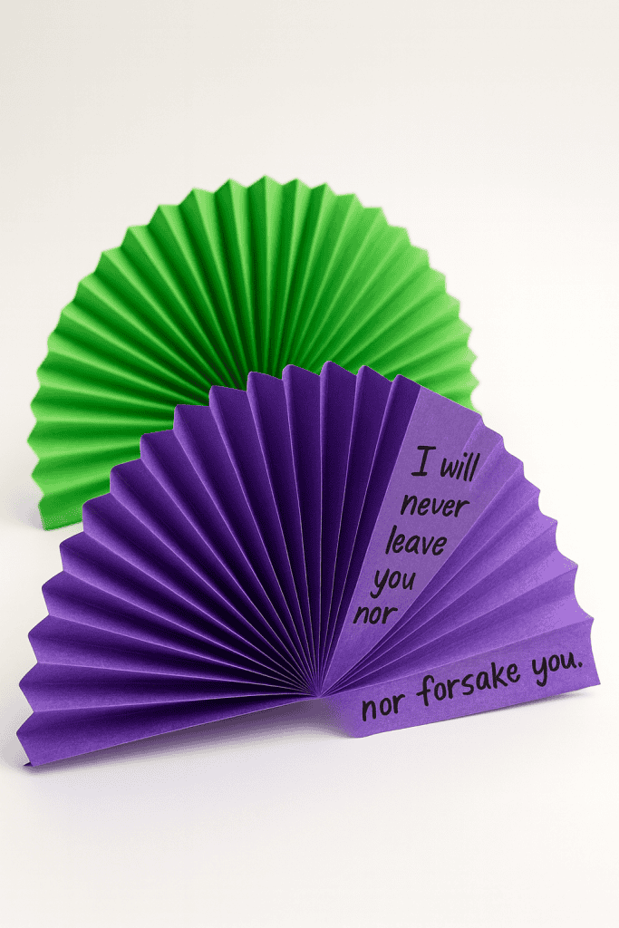 two paper fan crafts made from vibrantly colored construction paper
