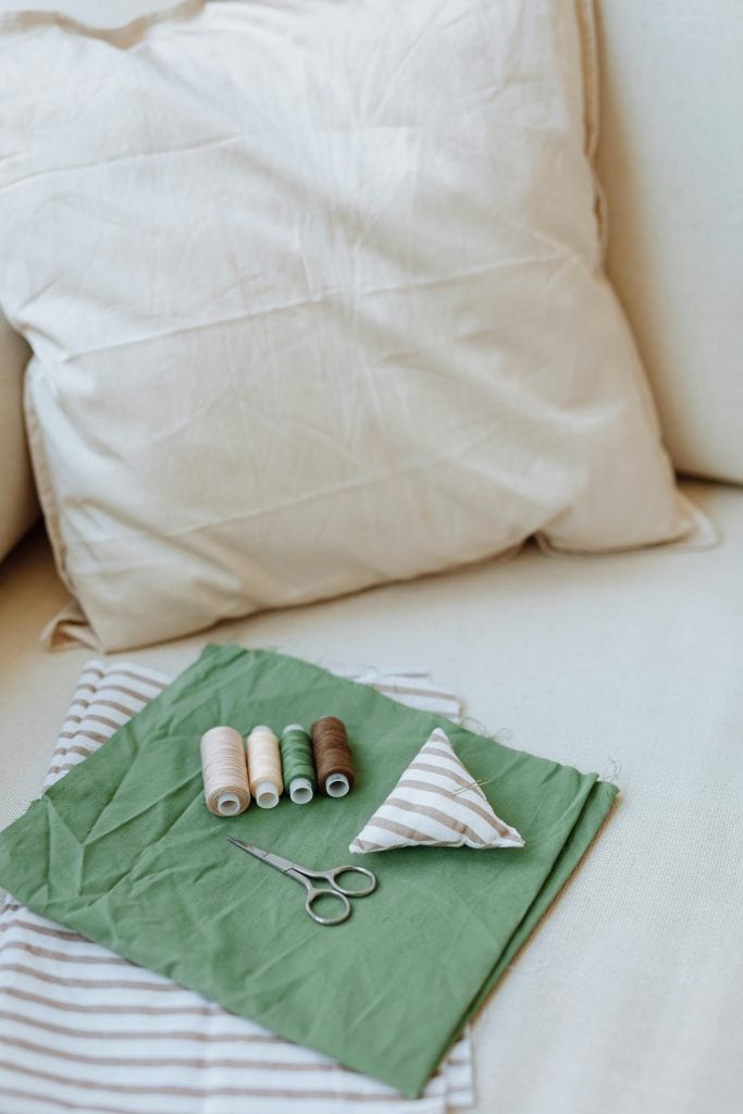 Sewing Materials over Green Fabric