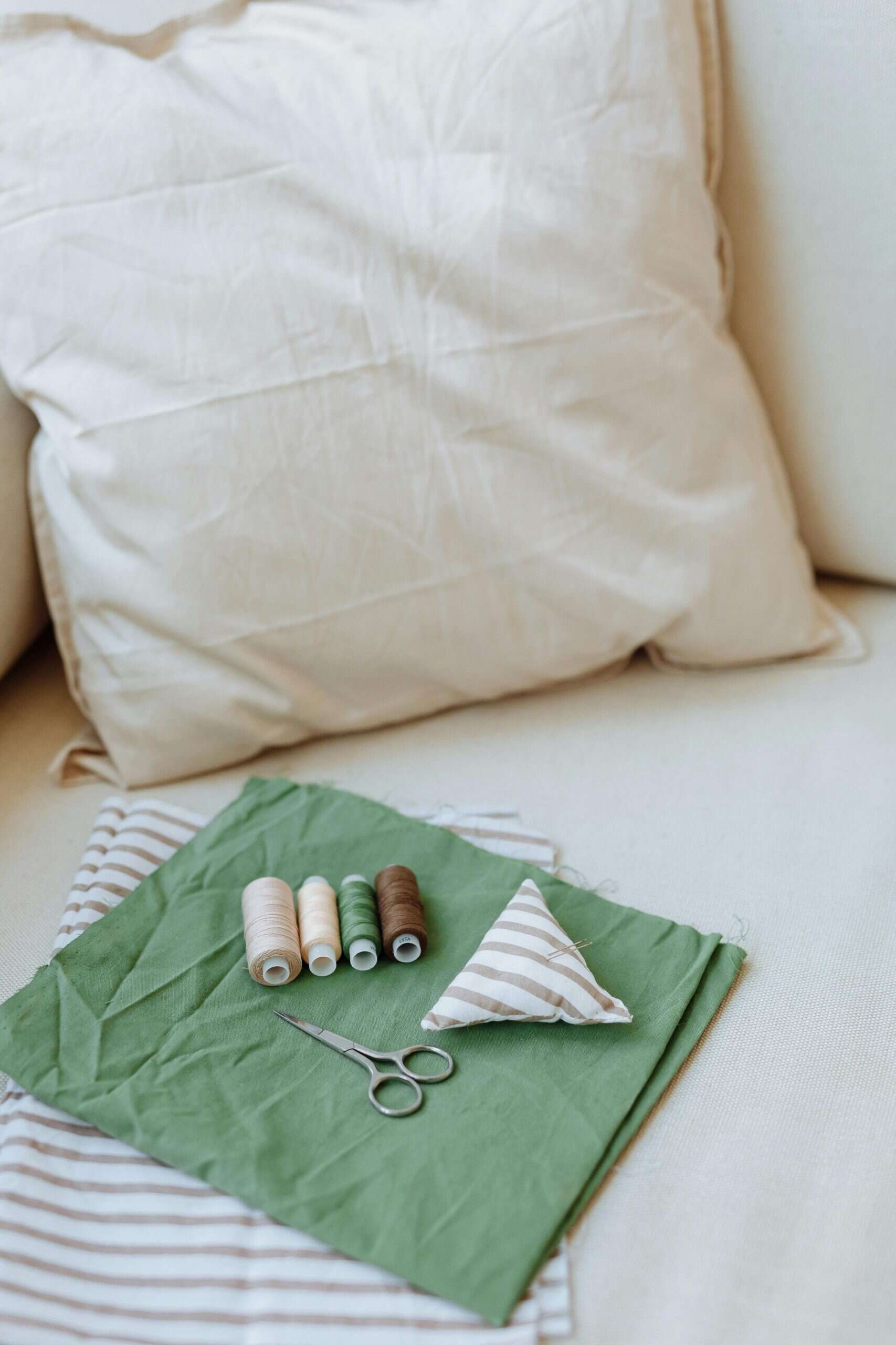 Sewing Materials over Green Fabric