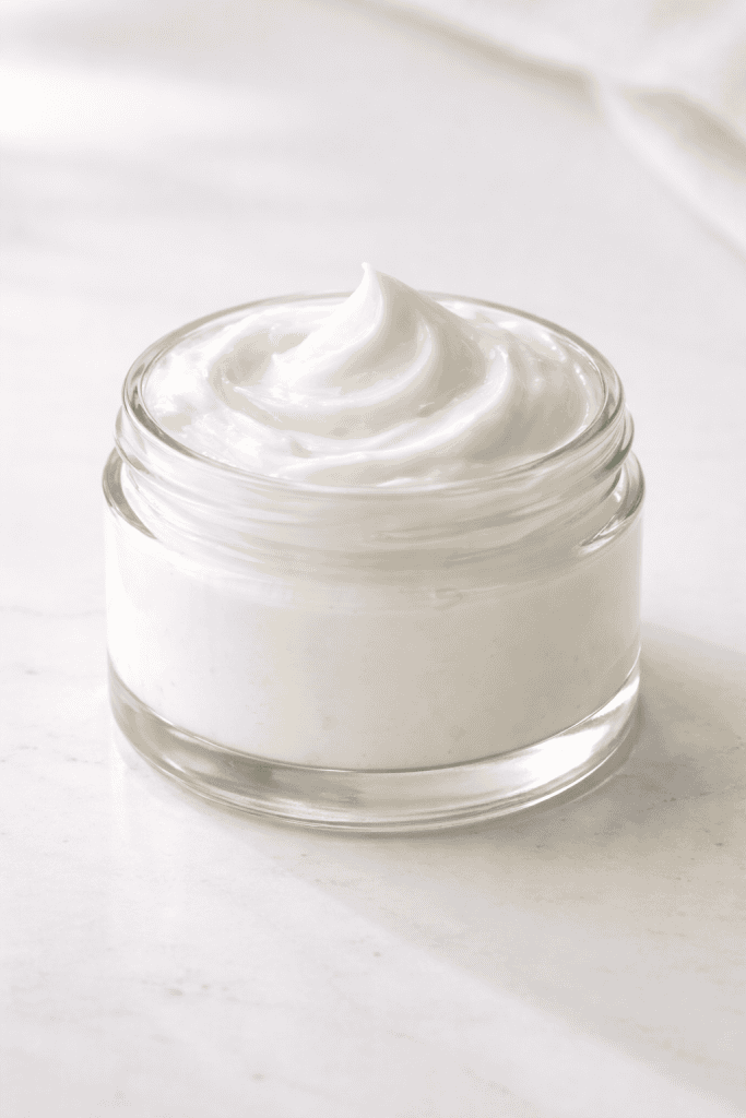 a homemade anti-aging hand cream in a simple, plain glass jar.