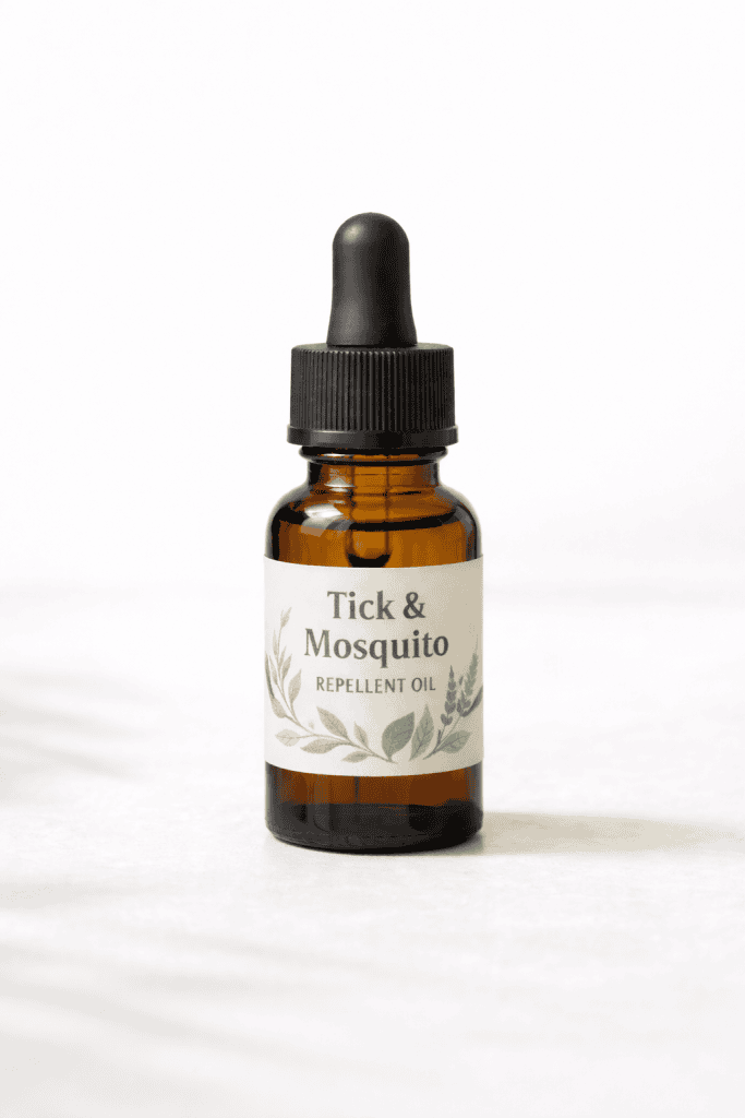 Tick and mosquito repellent oil in amber glass dropper bottle with botanical label on white background.