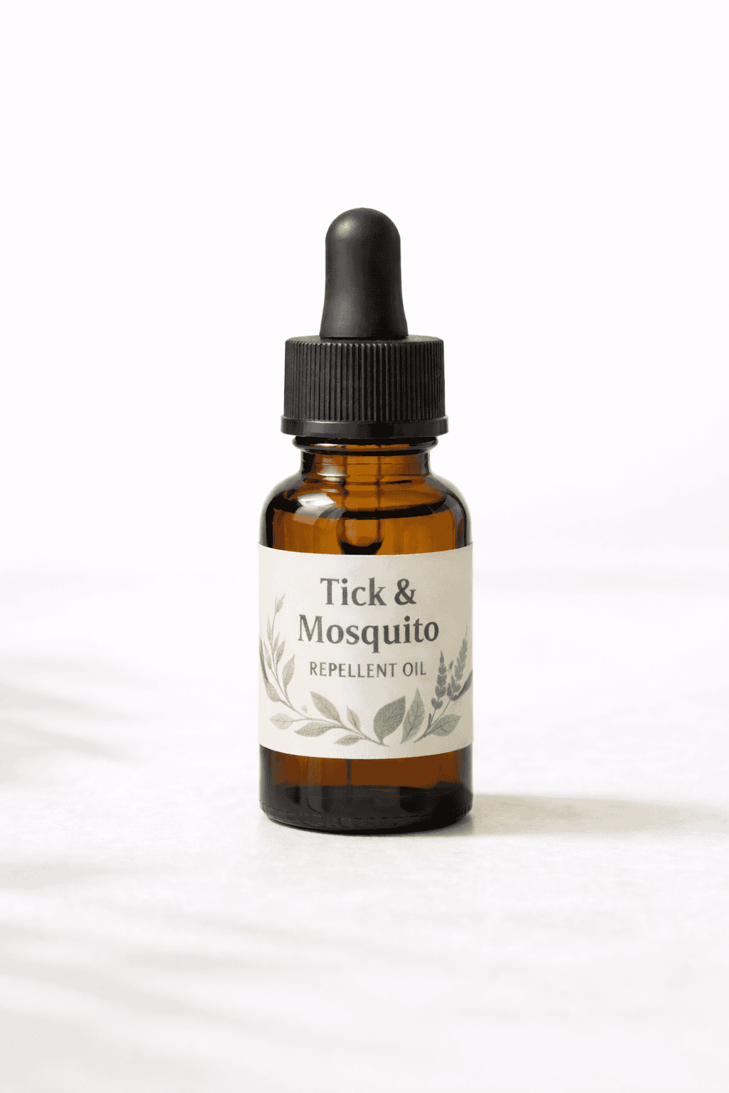 Tick and mosquito repellent oil in amber glass dropper bottle with botanical label on white background.