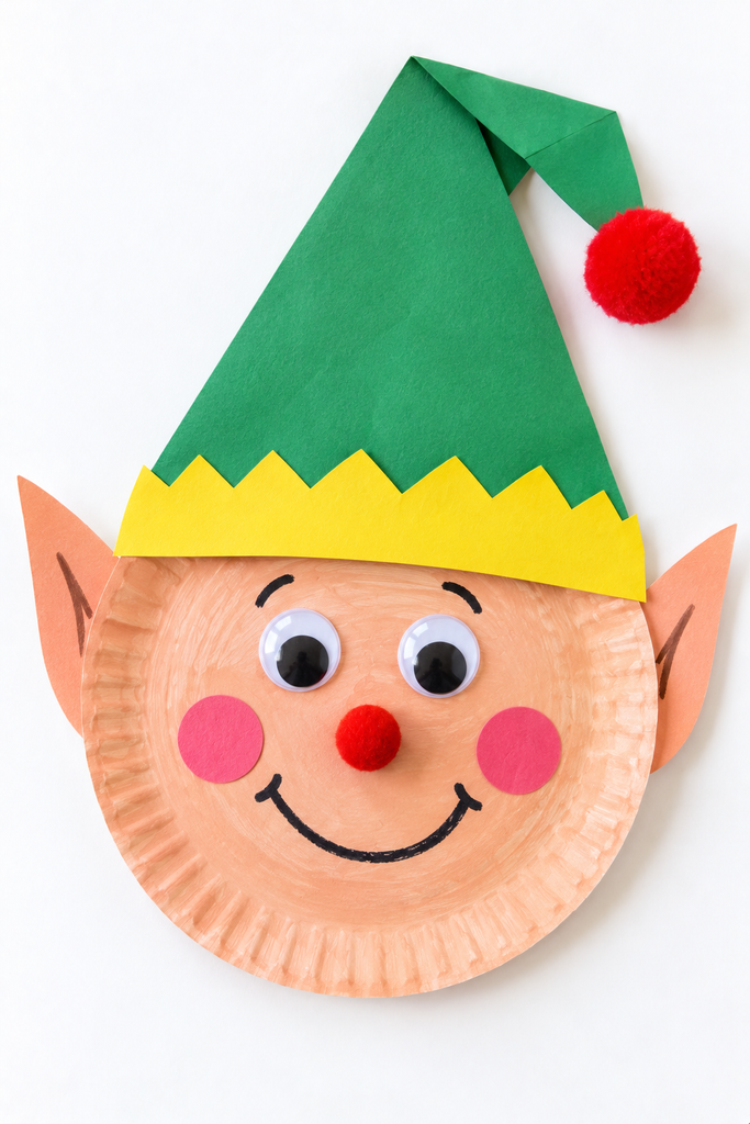 a paper plate elf craft with a peach face, folded green hat with a pom-pom, pointed paper ears, googly eyes, and rosy cheeks