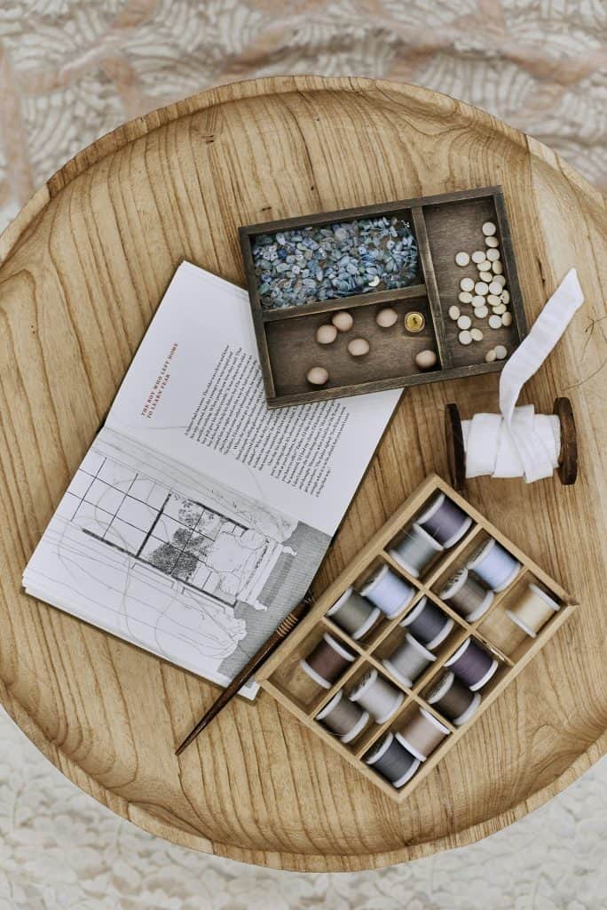 Close-up details of lace, beads, pearls, and threads used in fashion and tailoring. High-quality textile elements and handmade embellishments, showcasing the craftsmanship and elegance of garment design