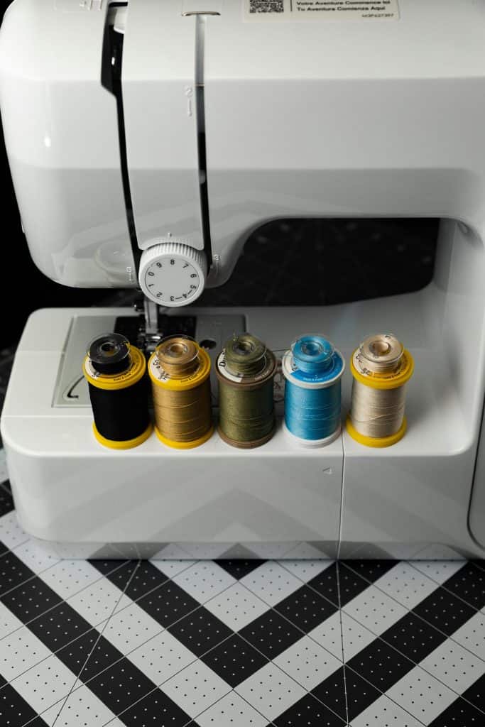 Sewing Machine with Colorful Threads Close-Up

