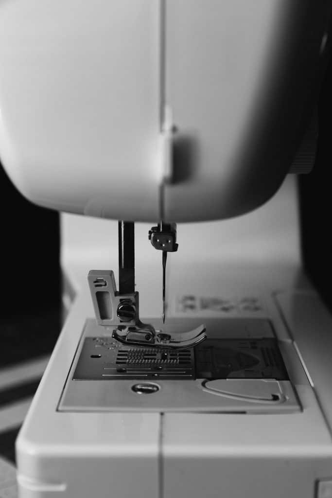 Close-up of an all-purpose zigzag sewing machine foot attached to the needle plate, ready for general stitching.