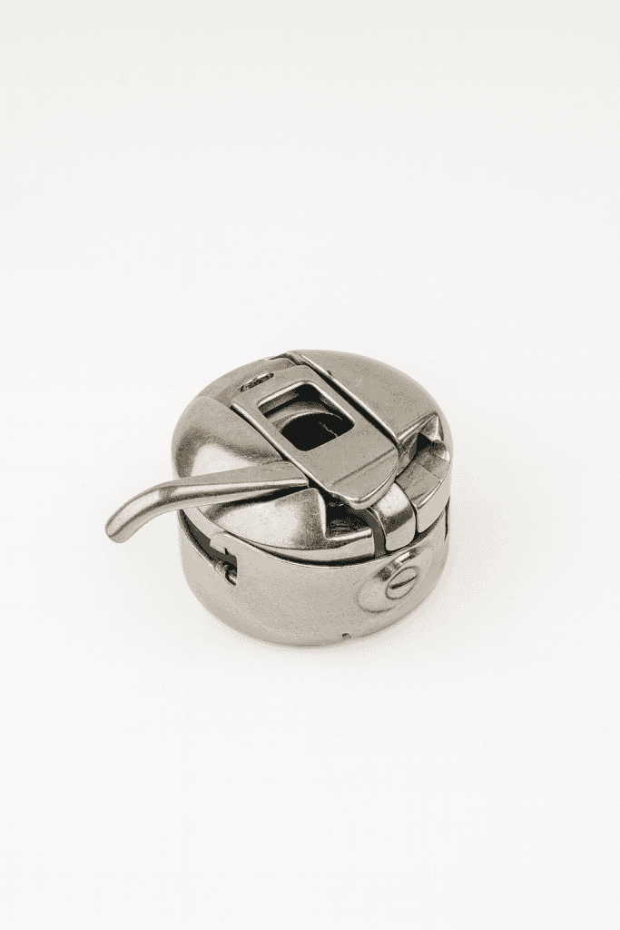 a close up image of a bobbin case