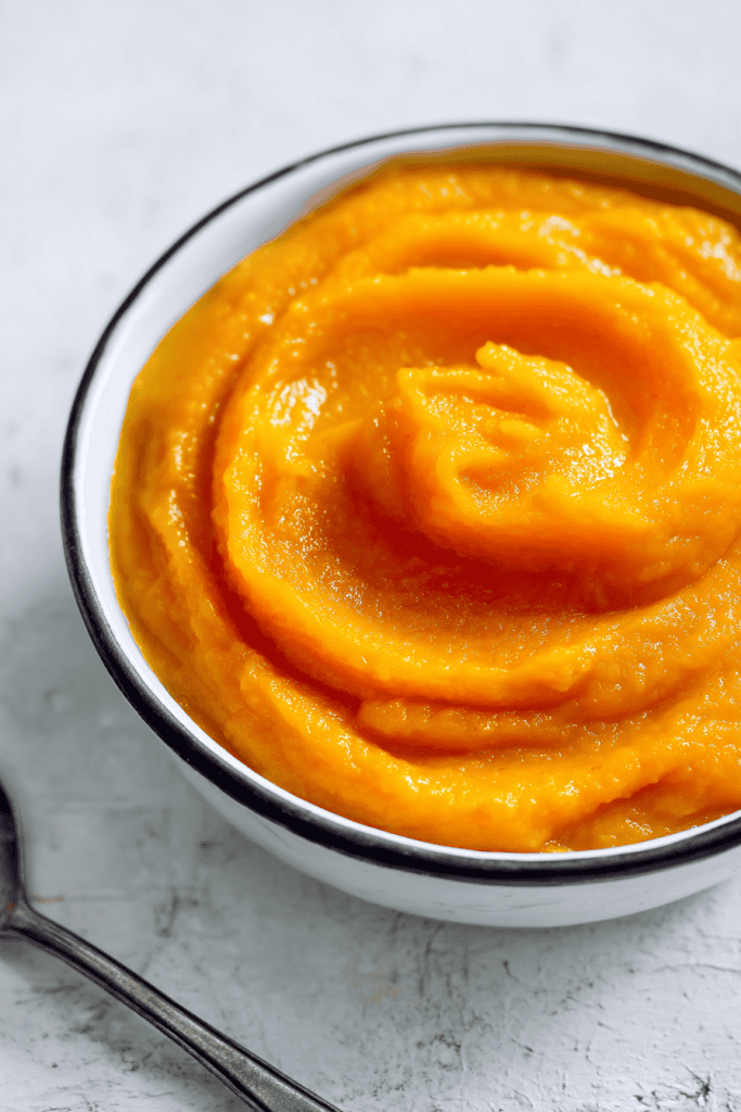 a bowl of smooth, vibrant orange pumpkin puree