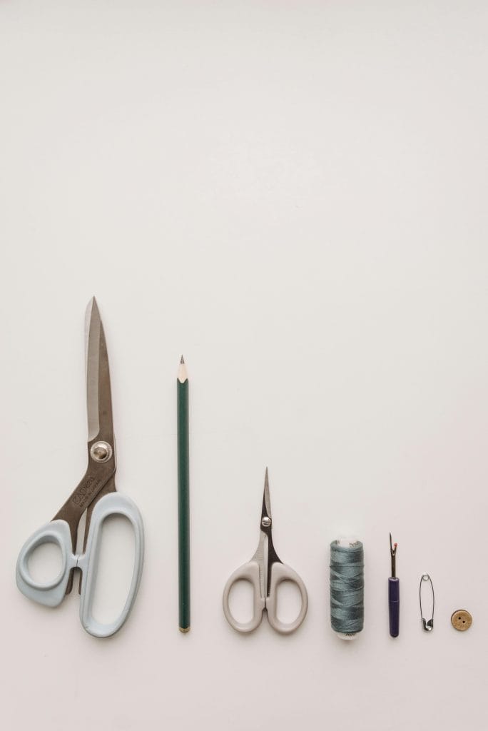 essential sewing tools meticulously arranged in a row