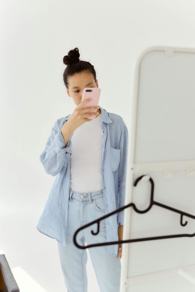 Female Taking a Photo in front of a Mirror
