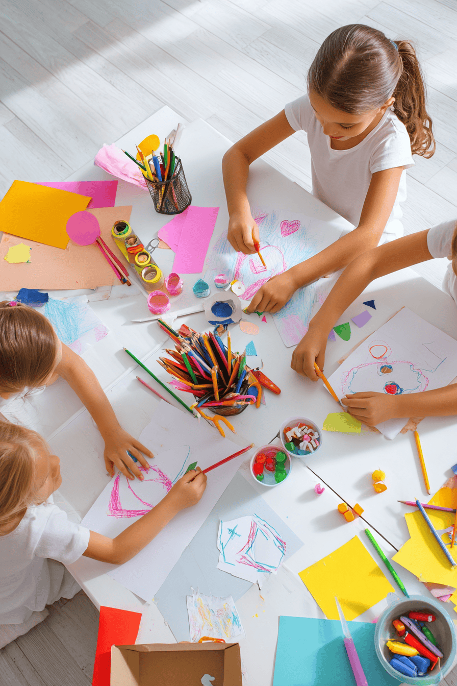 a Sunday School craft session in progress, featuring three young girls actively engaged in colorful paper-based crafts at a clean white table
