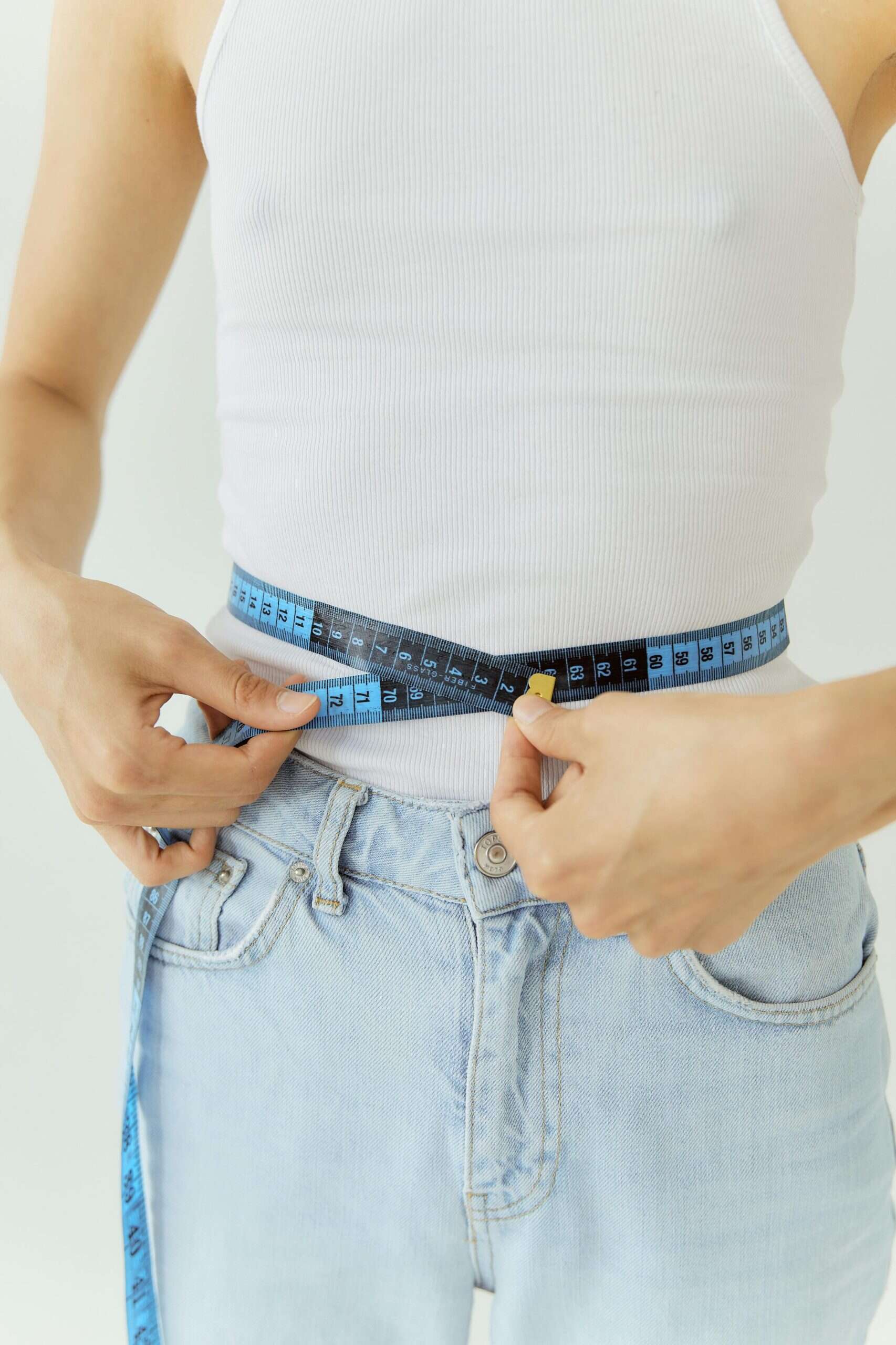 Woman measuring her waist