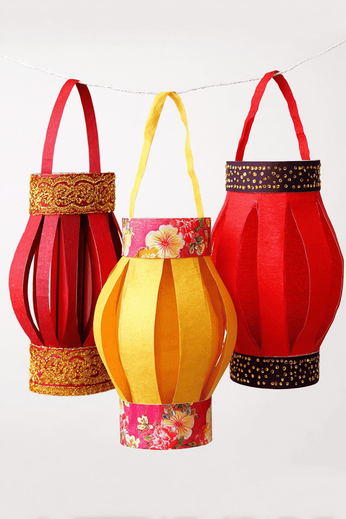 three colorful handcrafted paper lanterns hanging