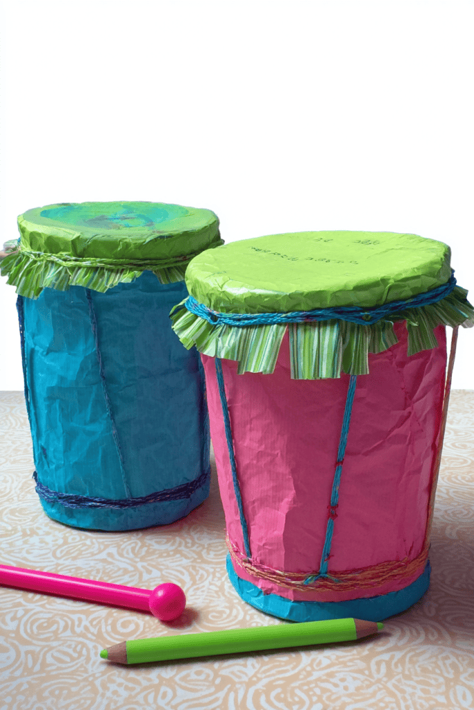 two colorful homemade toy drums crafted from recycled materials