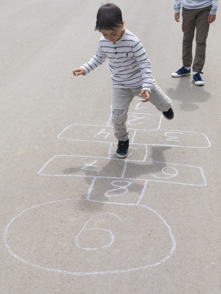 High view child playing hopscotch 