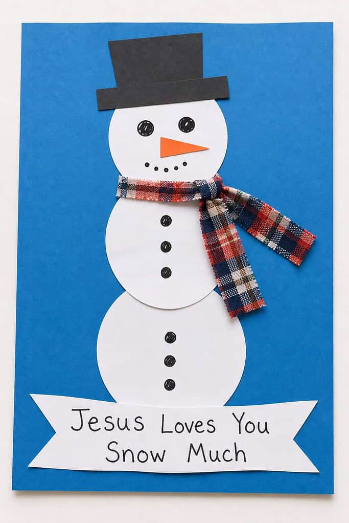 a handmade paper snowman craft with a hat and scarf and a banner reading Jesus Loves You Snow Much
