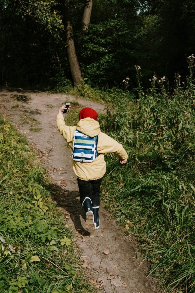 A child running on a dirt pathway