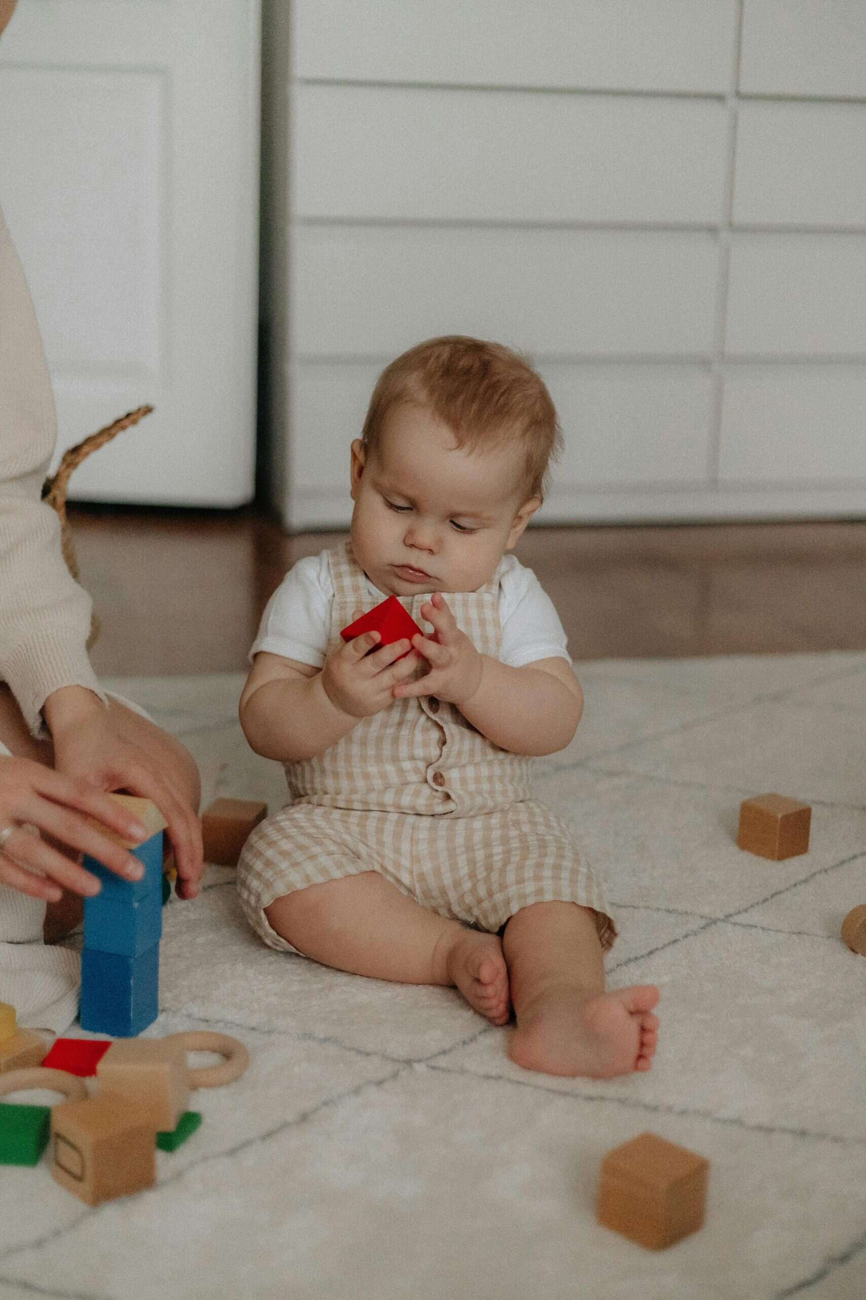 A Baby Holding a Toy