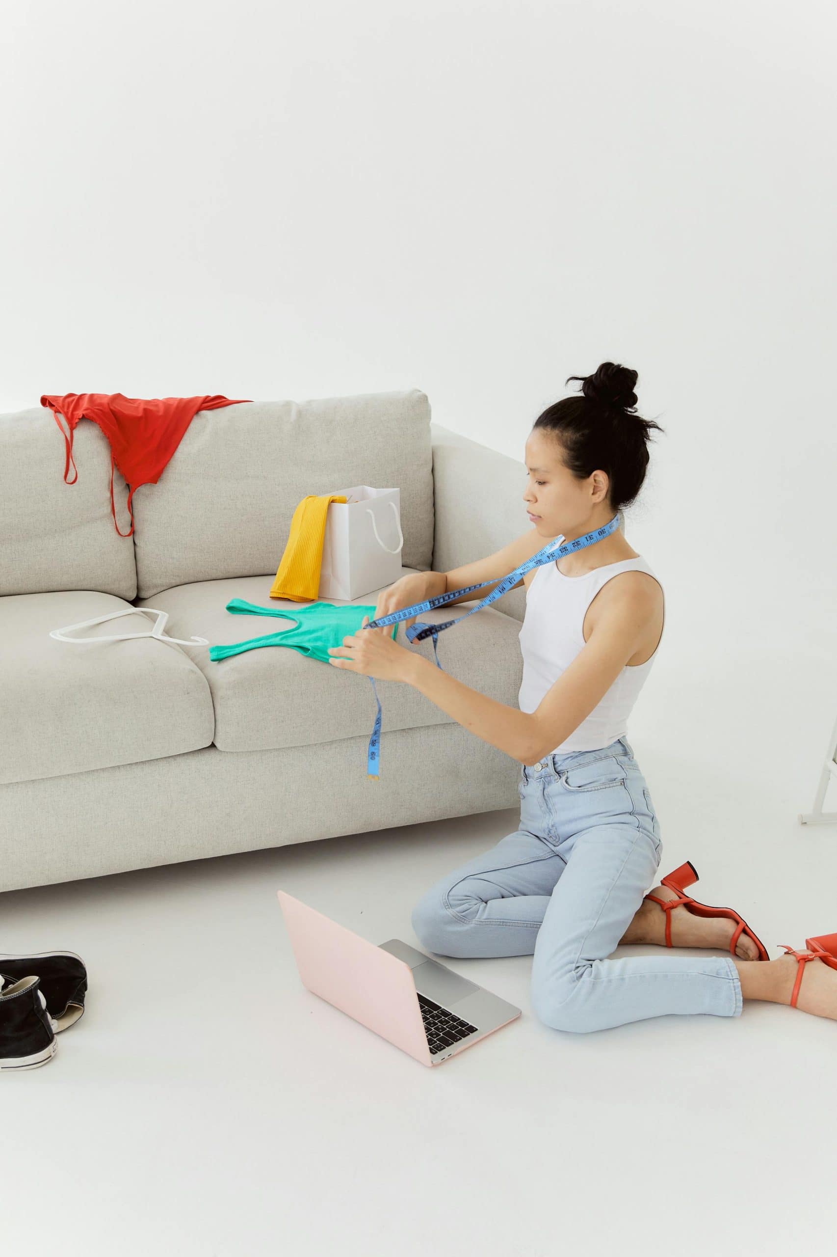 Woman in White Tank Top and Denim Jeans Sitting on the Floor