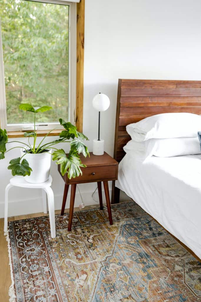 a minimalistic, modern boho bedroom corner with a warm and organic aesthetic