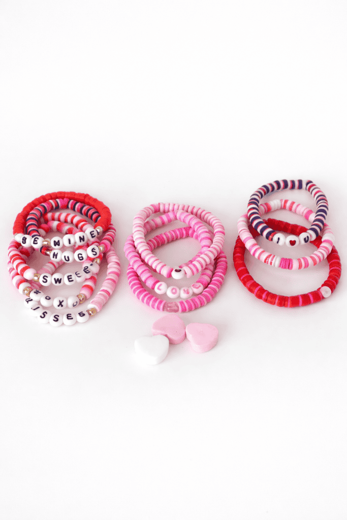 handmade Valentine’s Day beaded bracelets neatly arranged on a clean, neutral tabletop