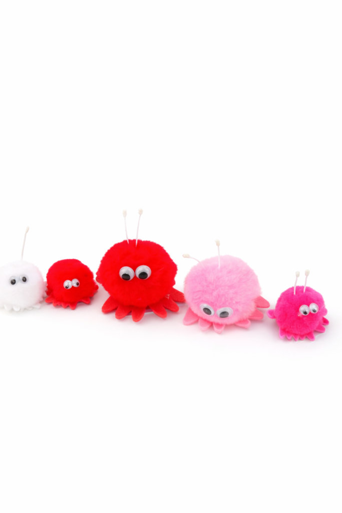 Pom-pom creatures lined up in row