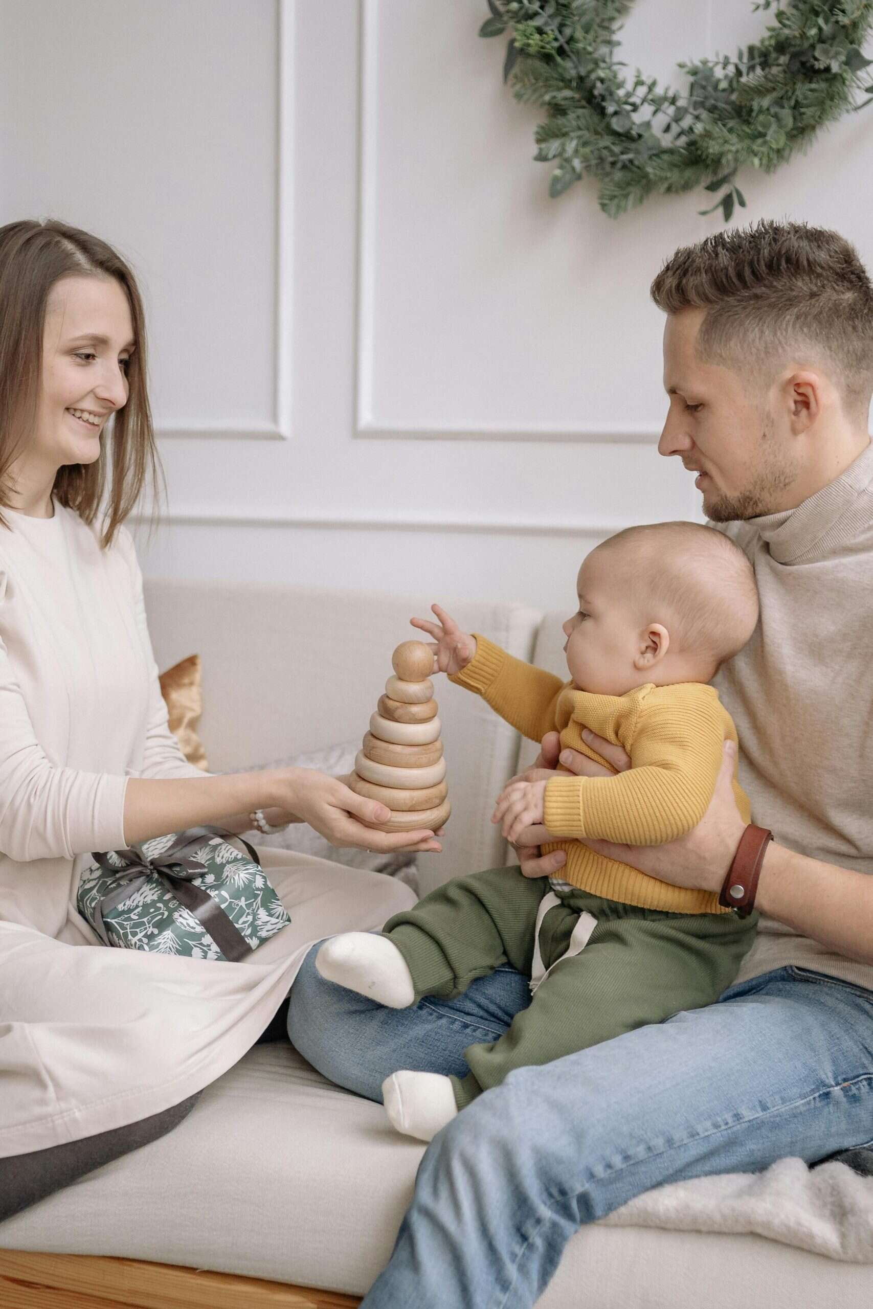 a young couple and their baby interacting during playtime