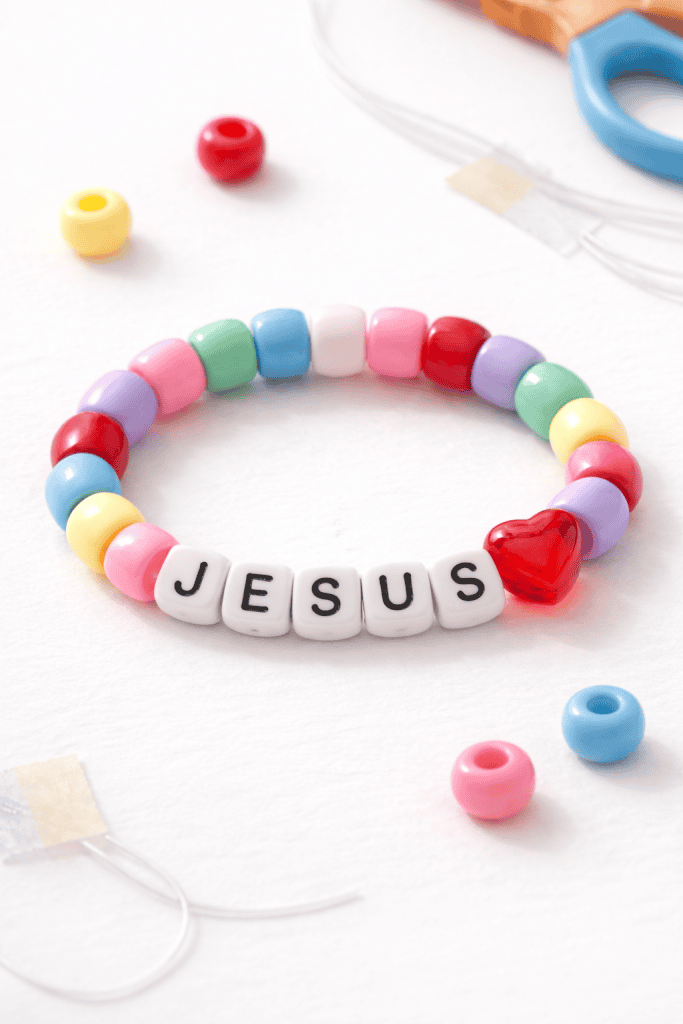 a toddler-made “Jesus Loves Me” beaded bracelet