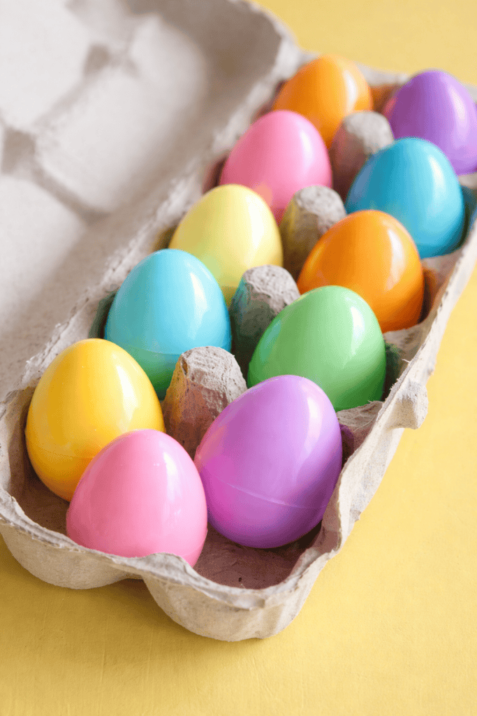 a Resurrection Eggs Hunt setup, featuring 12 colorful plastic Easter eggs placed neatly in a recycled cardboard egg carton