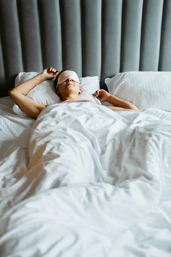 a person peacefully sleeping in a modern, luxurious bed