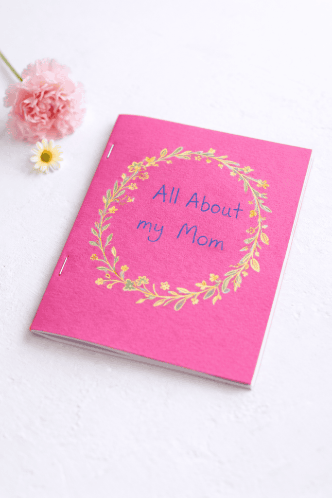 a vibrant pink Mother’s Day booklet placed on a clean white table surface