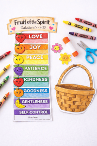 Fruit of the Spirit basket craft printable cut and colored, showing the accordion fruit strip and basket cutout on a white background with crayons, scissors, and glue.