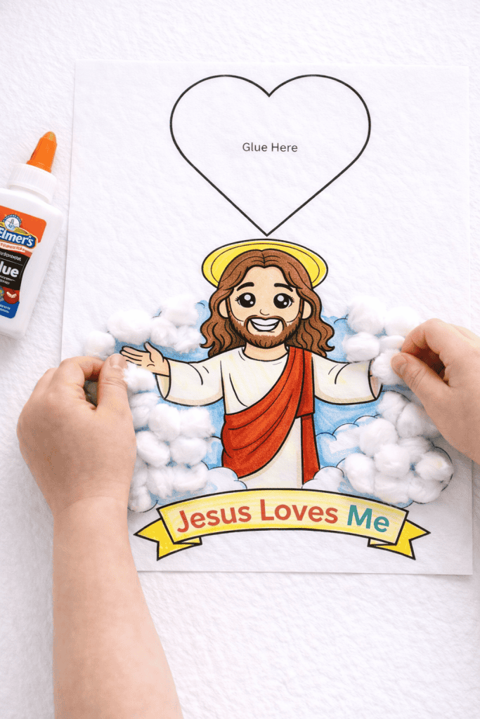 Decorating Jesus craft with cotton clouds