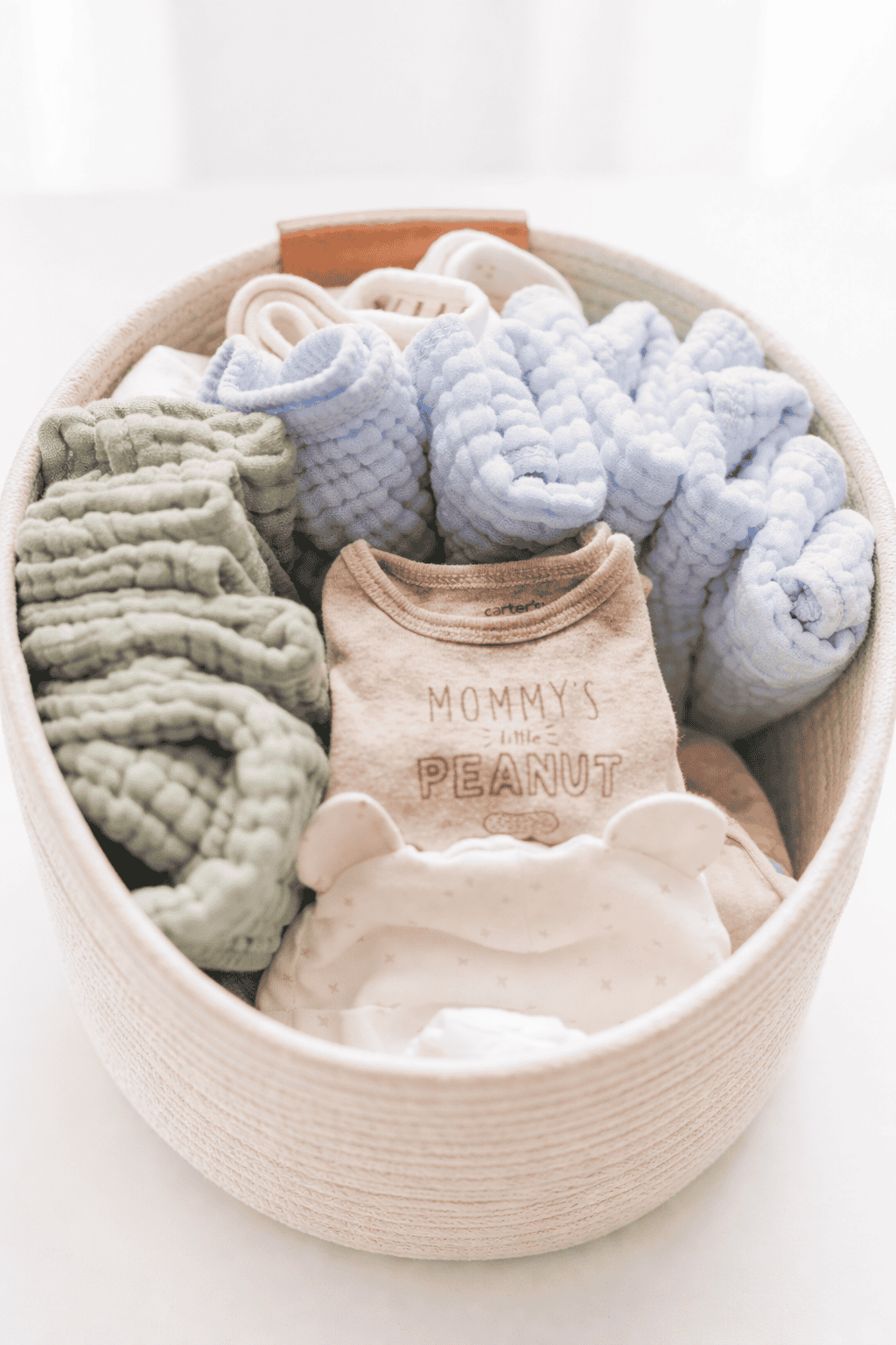 baby clothes in a basket