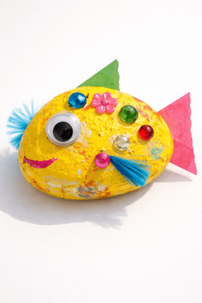 a colorful handmade painted rock fish