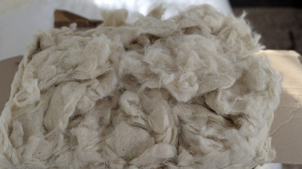 Close-up of natural wool stuffing used as pillow filling.