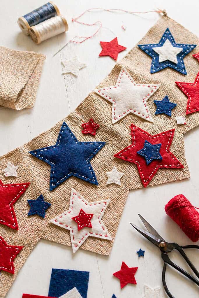 A horizontal banner made from natural burlap or plain canvas fabric, laid flat across the frame.