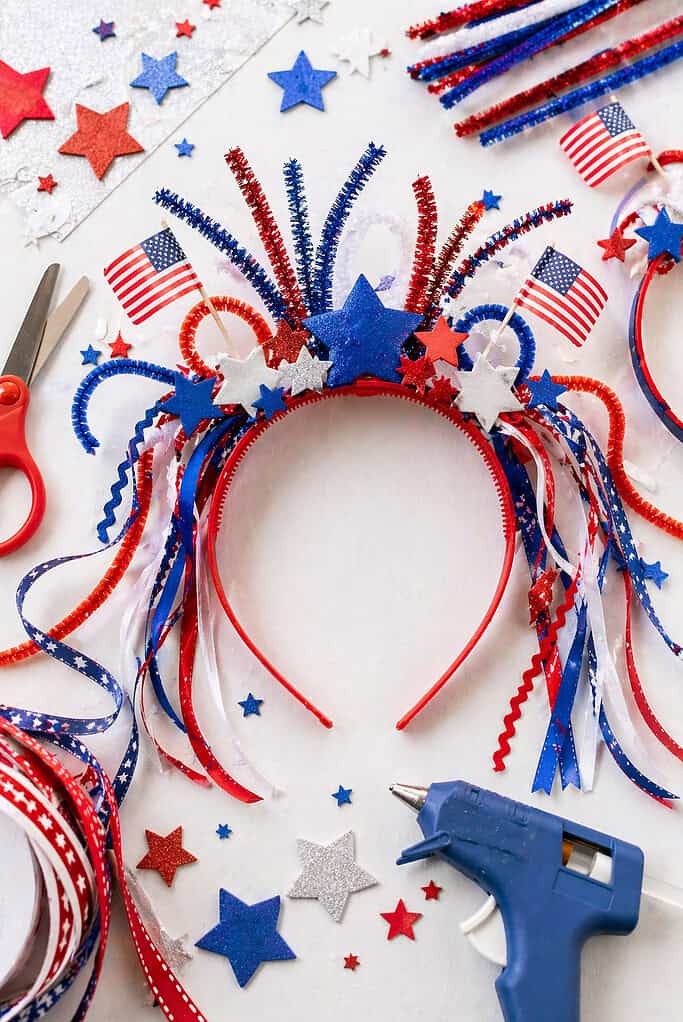 A decorated plastic headband placed centrally, styled as a festive crown.