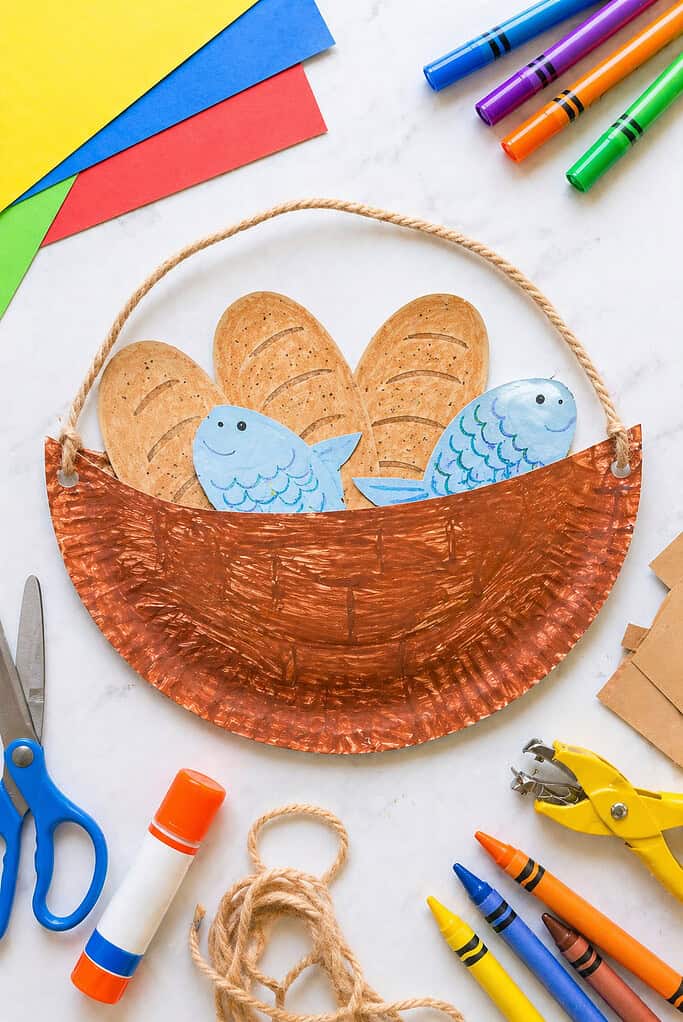 a handmade basket craft created from a half paper plate or folded construction paper