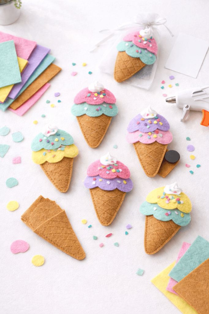 felt ice cream magnets arranged on a clean white table in a bright crafting space