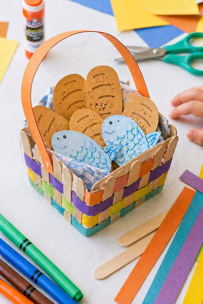 a small handmade picnic-style basket crafted from children’s materials