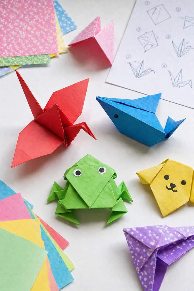 a small collection of origami animals made from colorful paper—include classic beginner-friendly designs such as a crane, a frog, and a fish