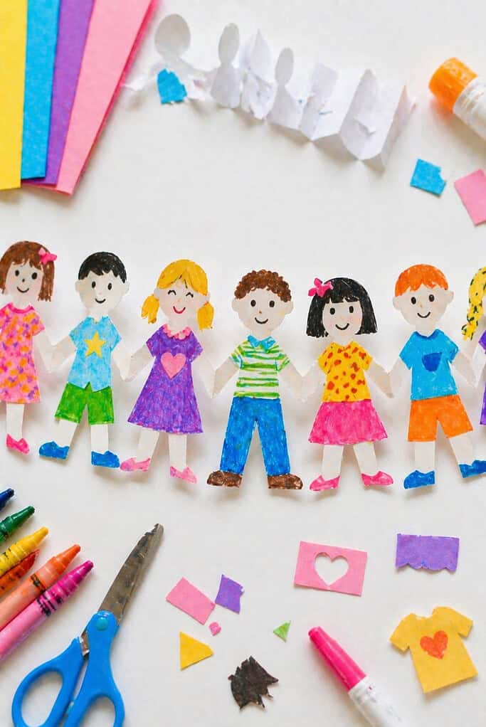 a fully unfolded chain of connected paper dolls made from a single accordion-folded strip of paper.