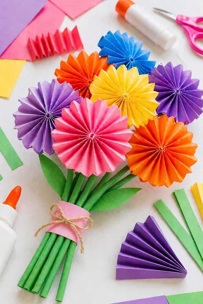 a small bouquet of handmade paper flowers created from accordion-folded sheets of colored paper.