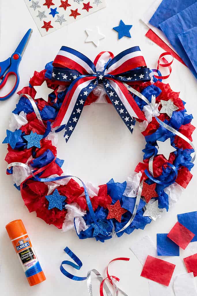 A paper plate wreath positioned slightly off-center, with the middle cut out to form a ring.