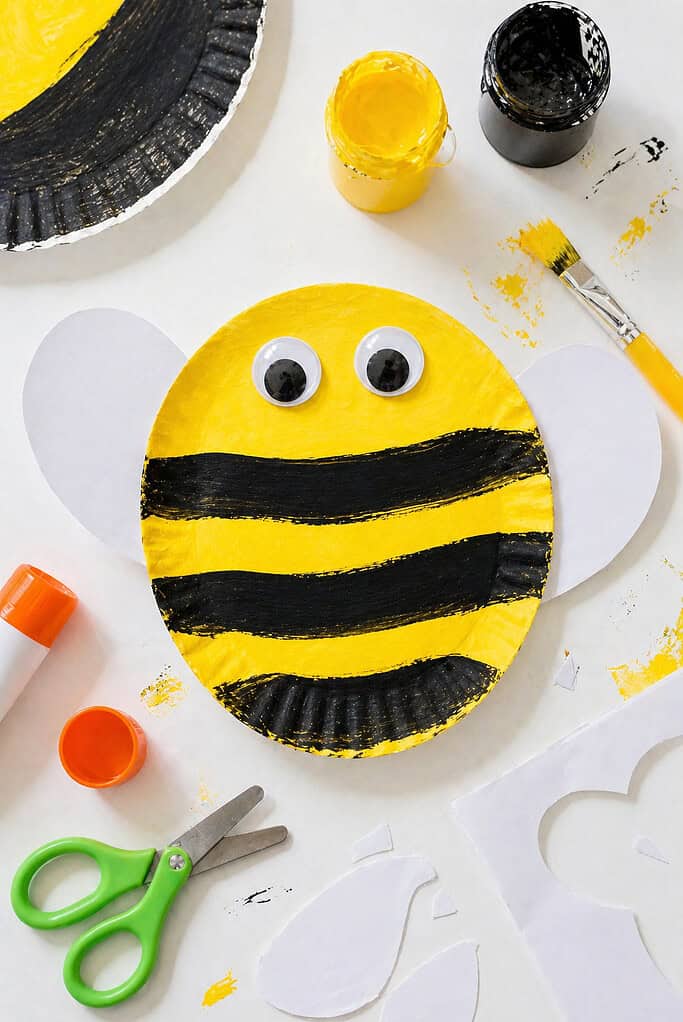 A paper plate cut into a simple bee shape