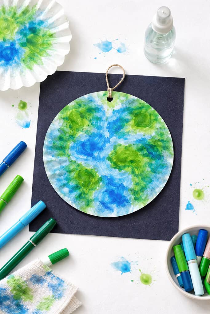 A circular coffee filter transformed into an Earth design, showing beautifully blended blue and green hues created by washable markers and water